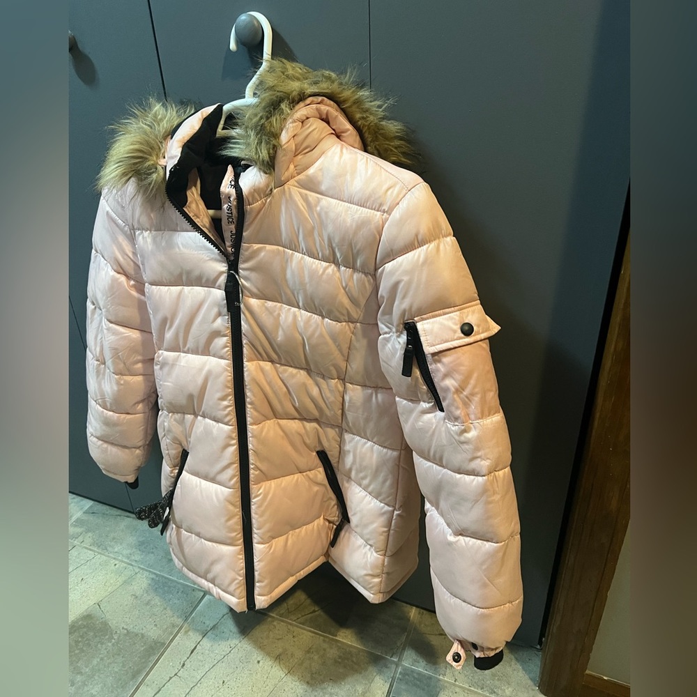 Pink puffy winter jacket with fur on the hood and adjustable wrists on the sleve